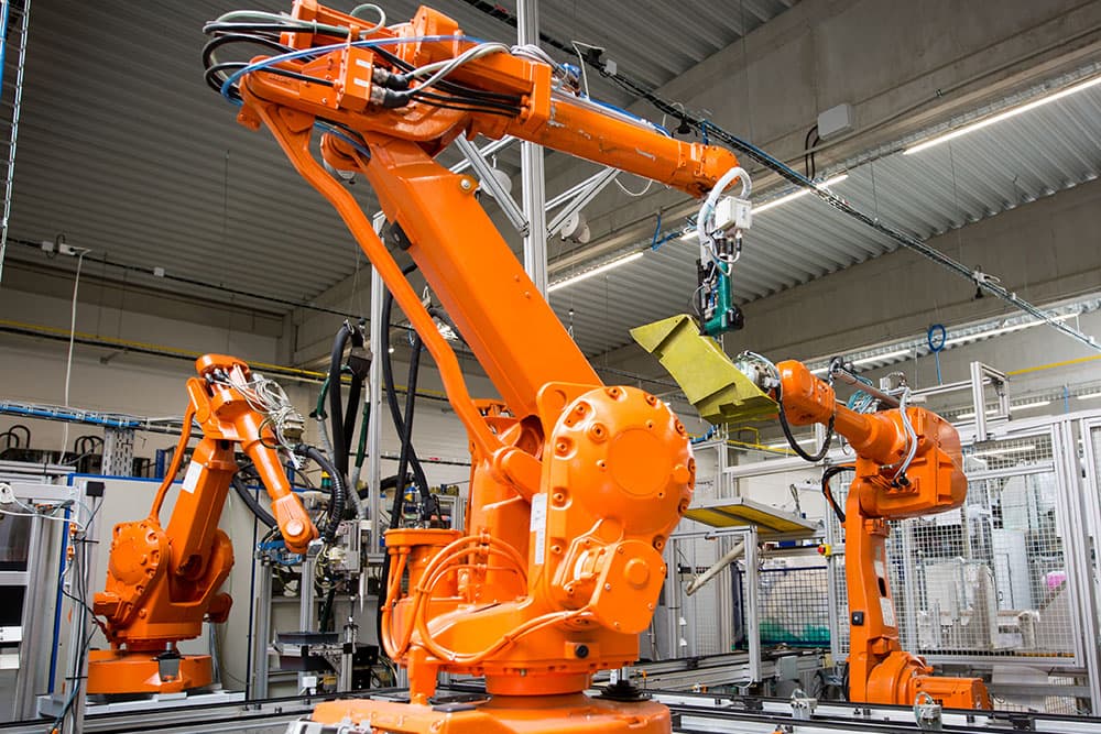 Industrial robot arms on a production line